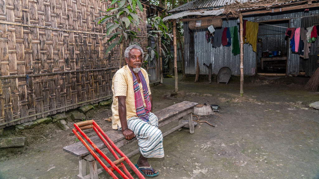 A man who is missing a leg, sitting outside.
