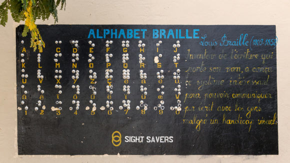 The alphabet painted onto a wall, with the braille under each letter.