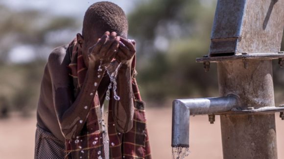 A boy washes his face at a well in Turkana, Kenya. Good hygiene is key to reducing the incidence of Trachoma and other eye conditions.