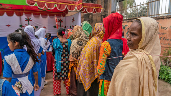 Women waiting in a queue to get their eyes checked.
