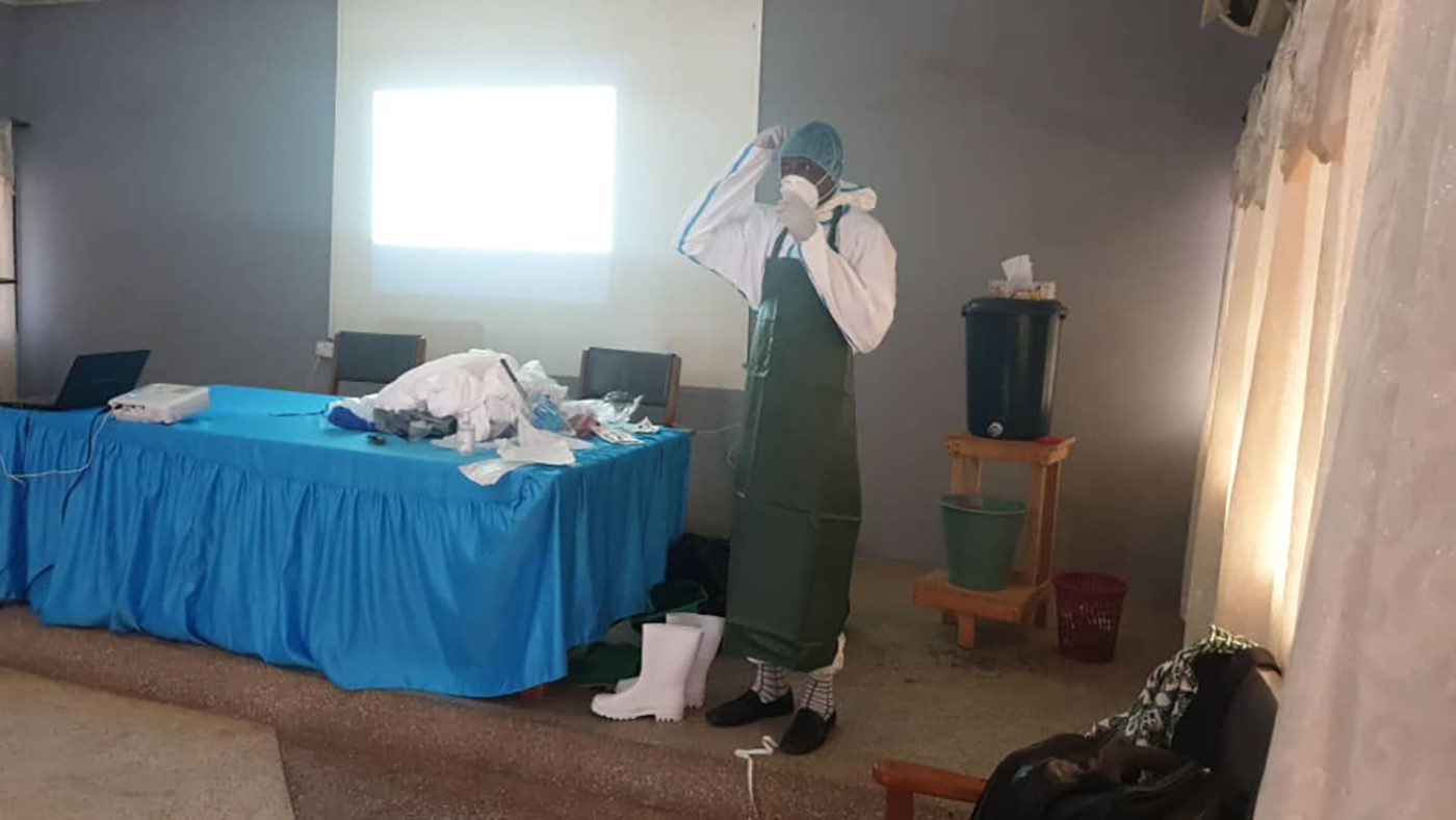 A man wears personal protective equipent.