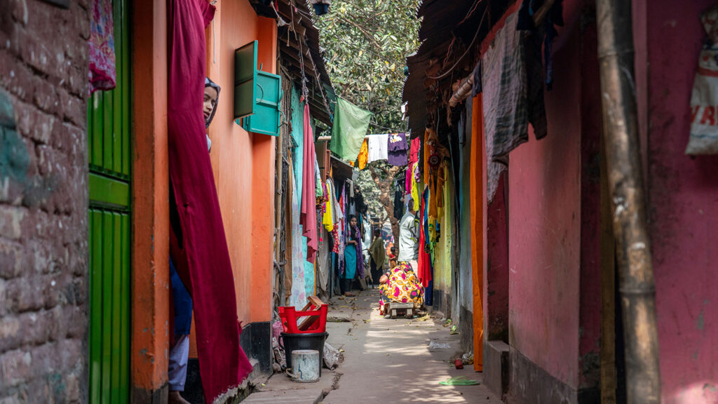 A slim walkway through an informal urban settlement