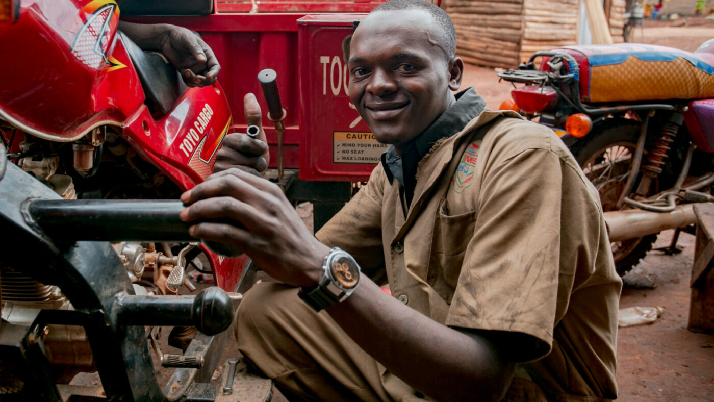 A man fixes a vehicle.