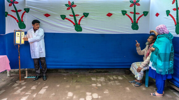 A doctor conducts an eye sight test.