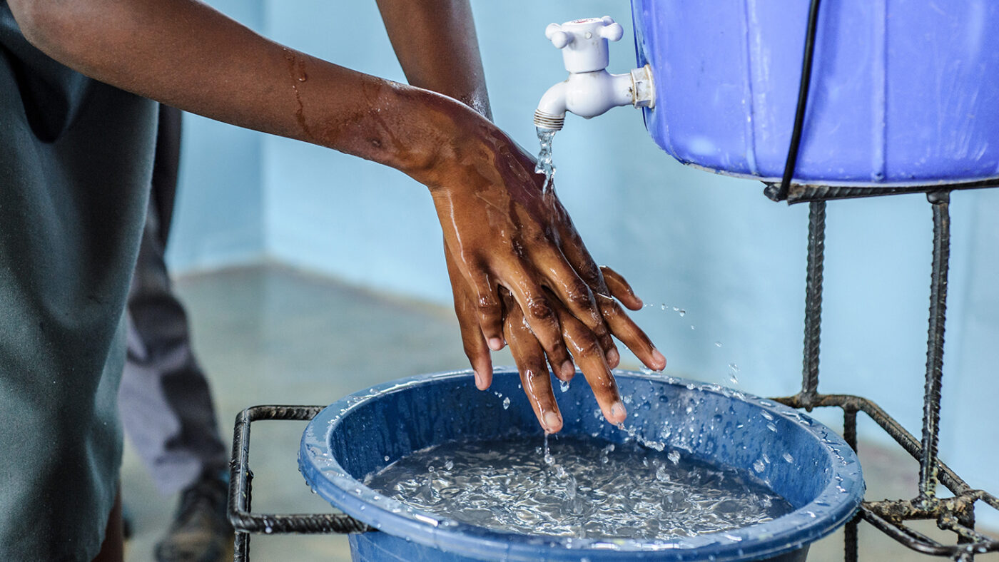 A close up photo of someone washing their hands.