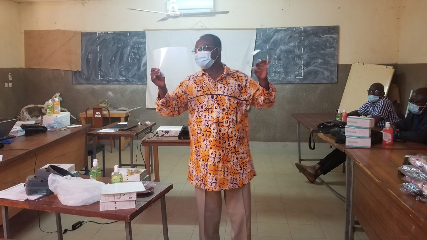 A teacher gives a lesson in a classroom.