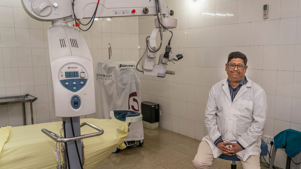 A man sitting in a operating theatre,