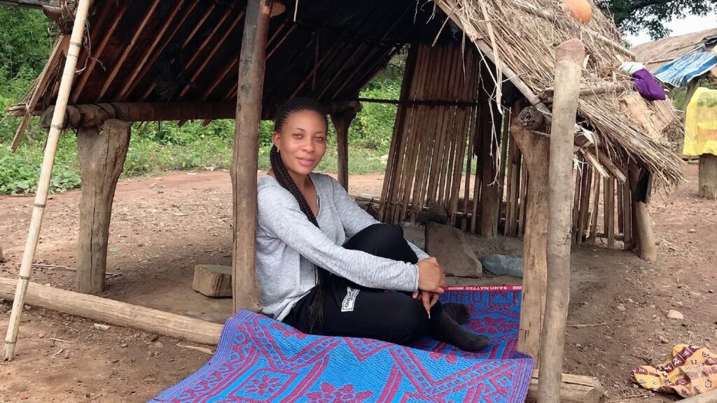 Kareem sits outside at the entrance of a nomadic hut.