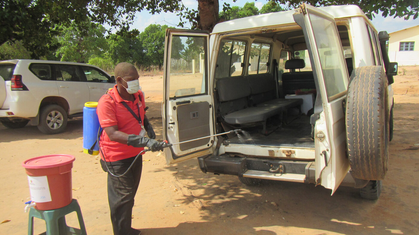 A man spraying the inside of the vehicle.