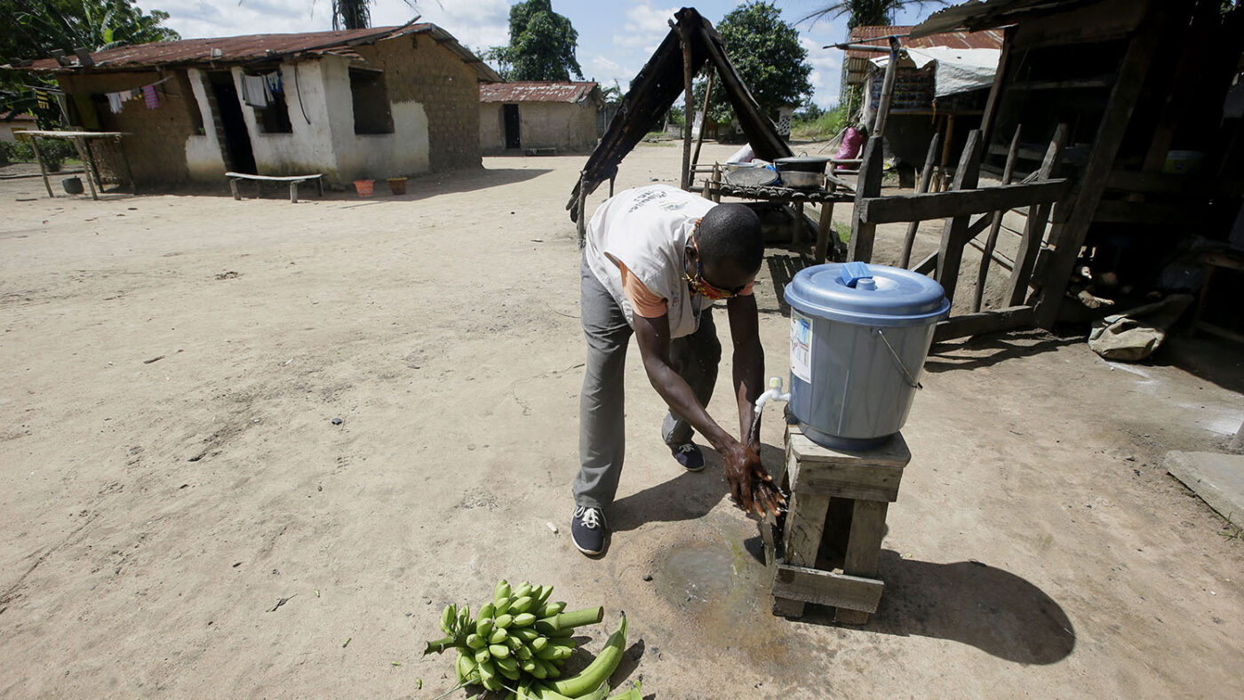 A man washes his hands.