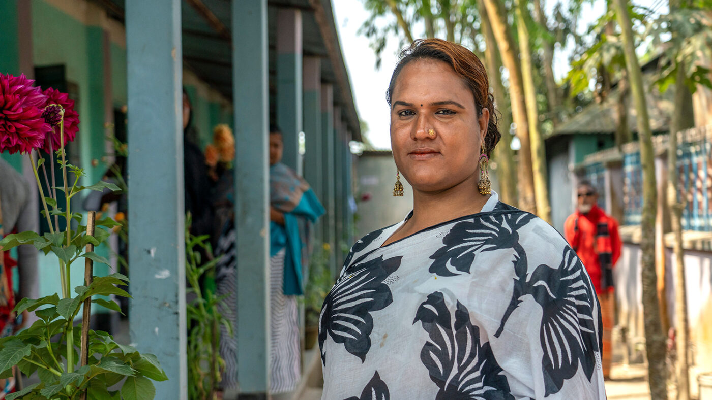 A women standing outside smiling.
