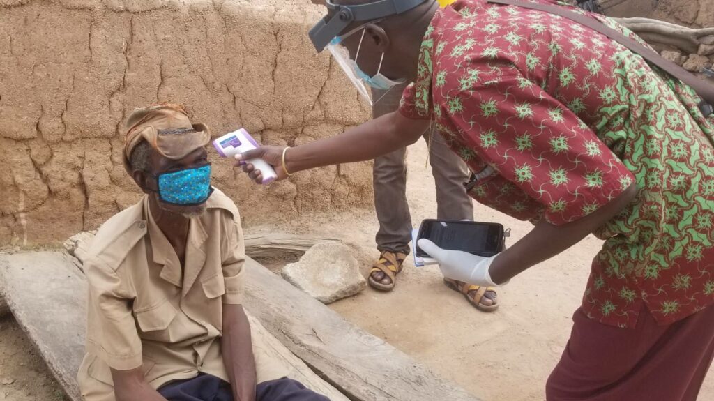 Investigator taking patient temperature before examination for trachoma