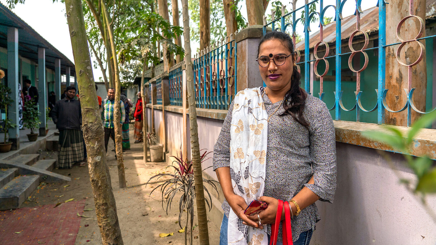 A women standing outside smiling.