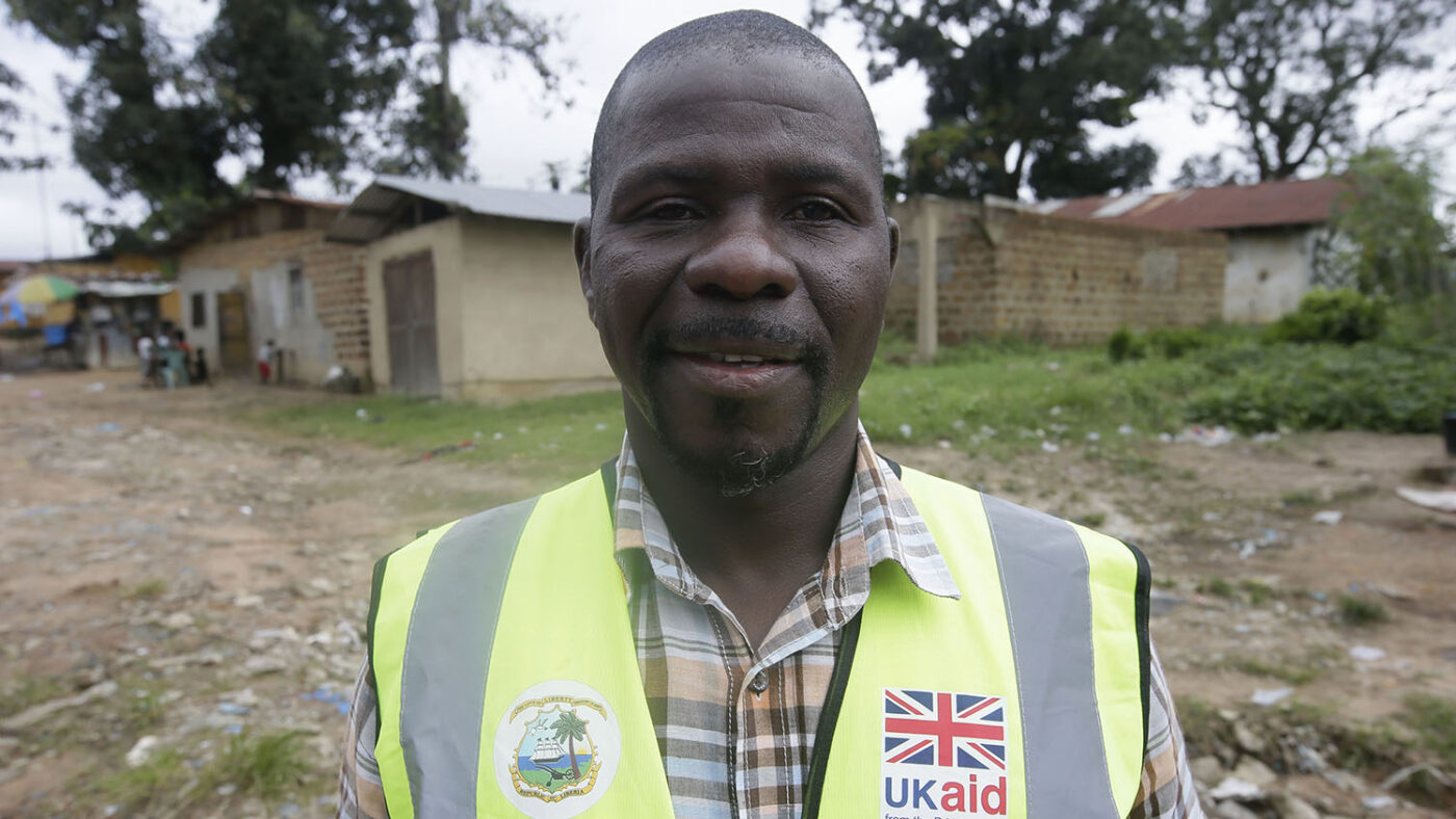 A man stands for a portrait outside.