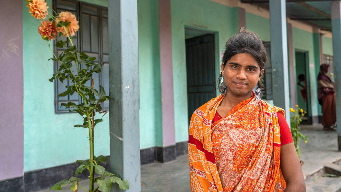 A women standing outside smiling.