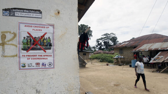 A poster displayed on a wall featuring the text Avoid crowded-up places to prevent the spread of coronavirus.