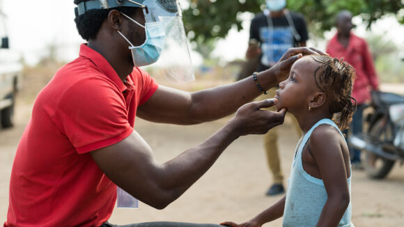 A trachoma grader looks at a child's eyes to check for signs of the disease.