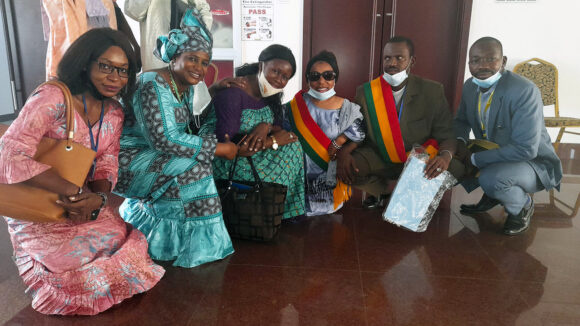 Five people, including the President of the Association des People of Small Size and the President of the Malian Union of the Blind, smile at the camera.