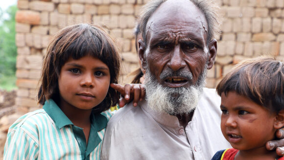 A man with his grandchildren before he has cataract surgery.