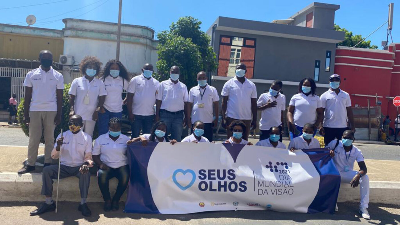 A group of people in Mozambique gather for a photo during World Sight Day celebrations.