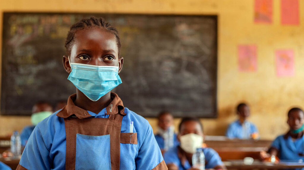 Ngo stands in her classroom wearing a face mask.