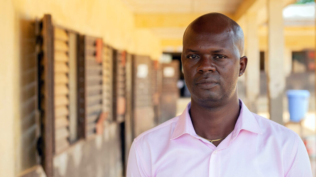 Bomam Otto stands outside his school in Cameroon.