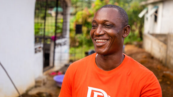 Joe smiles as he looks off-camera.