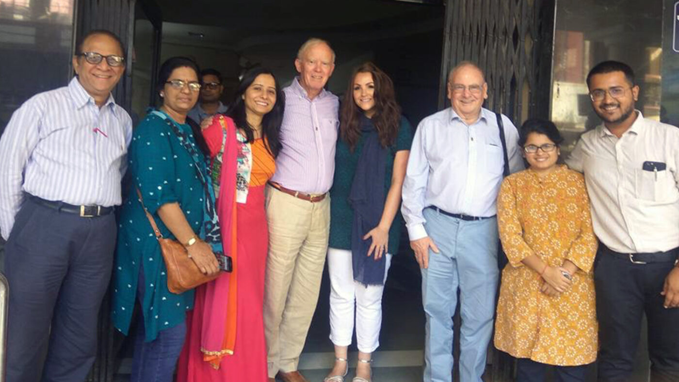 A group of seven people gather for a photo outside Sewa Sedan Eye Hospital.