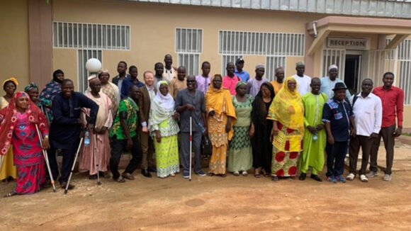 Voluntary local review workshop attendees gather outside for a group photo.
