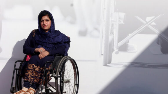 Disability rights activist Mehnaz sits in a wheelchair outside the National Assembly of Pakistan.
