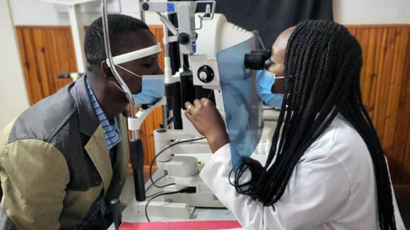 Ophthalmologist Moira performs an eye test on a patient.