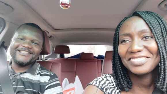 Moira with her husband in a car.