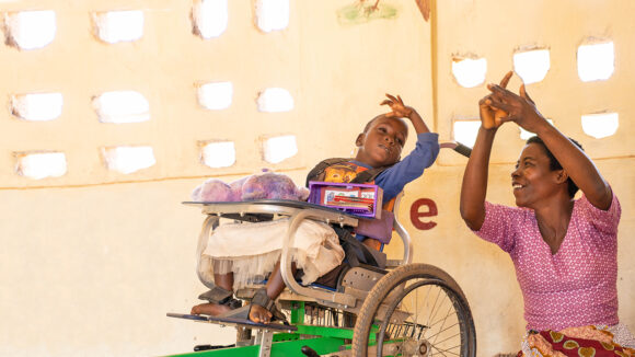Nora teaching Glory, one of her students, how to count.