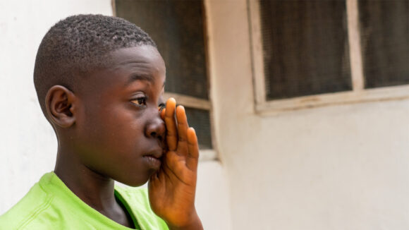 Arthur rubs his left eye with his left hand