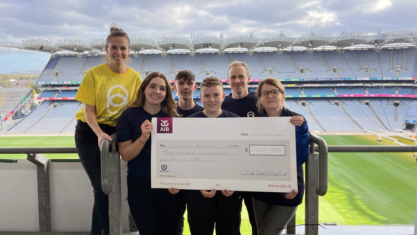 Sightsavers' Ciara Smullen and students and staff from Colaise Losaef pose with a cheque for sponsorship money they raised.