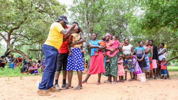 Ndumiso Ndlovu examines a queue of people for eye conditions, including trachoma.