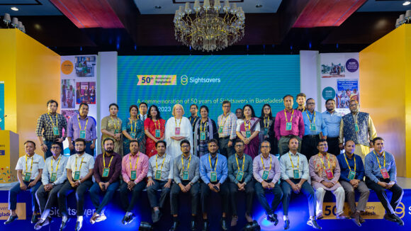 Sightsavers' CEO Caroline Harper poses for a group photo with staff from Sightsavers Bangladesh during its 50th anniversary celebrations in Dhaka.