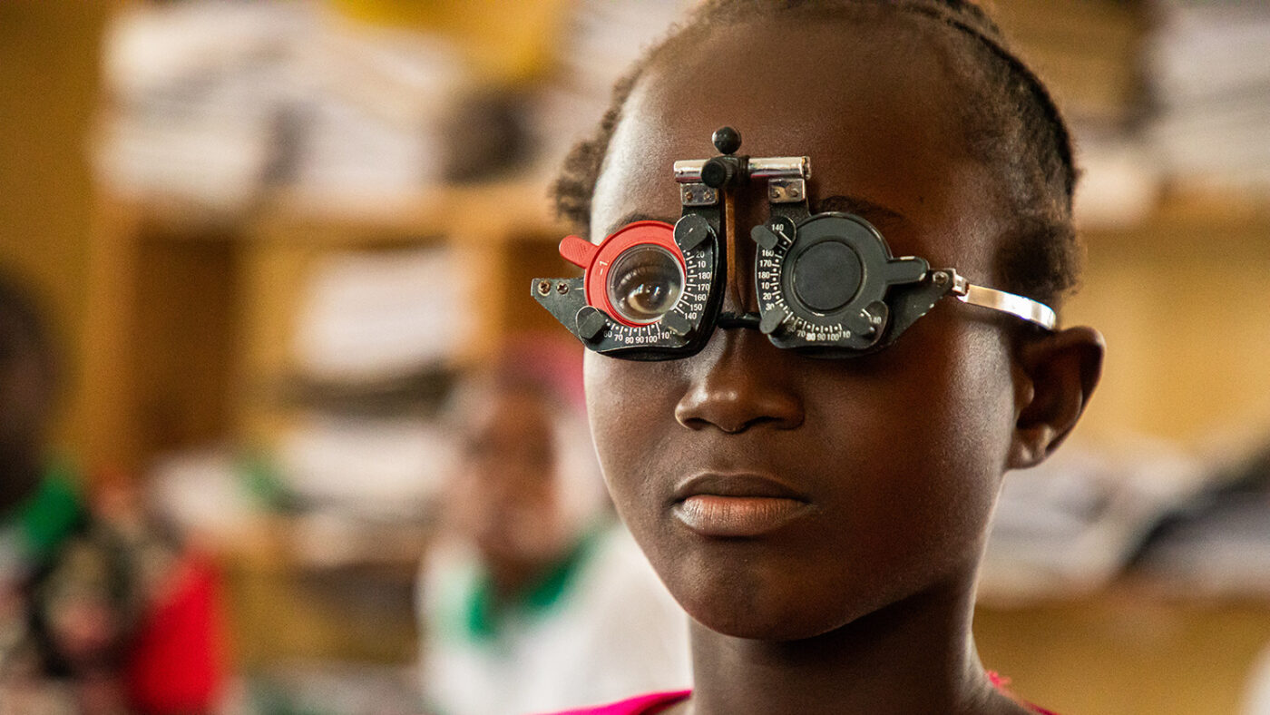 Facial gets her eyes tested at school in Liberia.