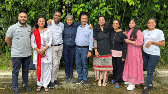 Members of Transforming Communities for Inclusion pose for a group photo.