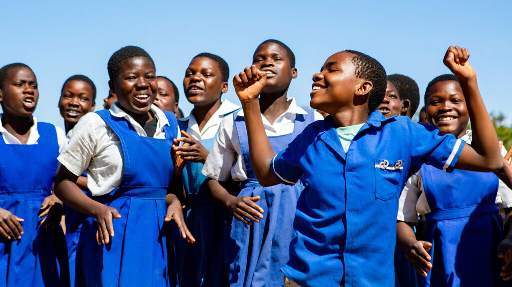 A group of students celebrating the elimination of trachoma in Malawi.