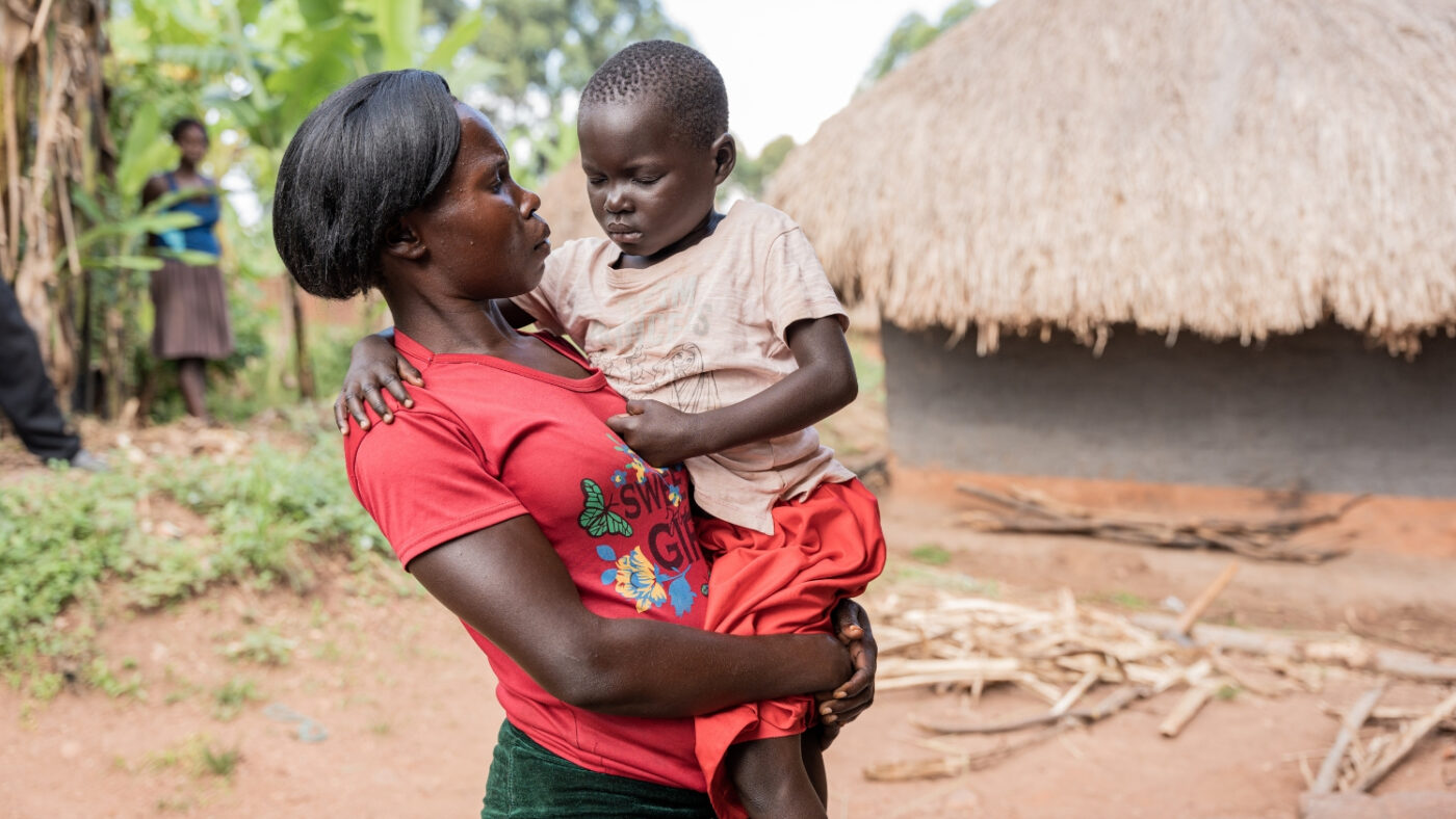 Fosca carries her daughter, Happy, who has her eyes closed.