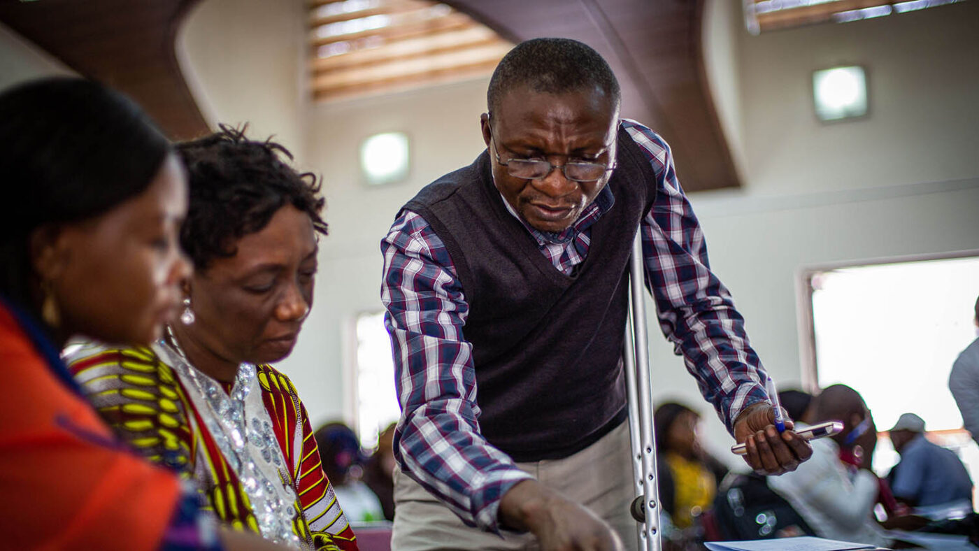 Dr Valentin guides two women during a workshop in Kinshasa.