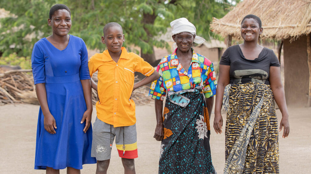 Angeshita with her daughter and two granddchildren outside her home.