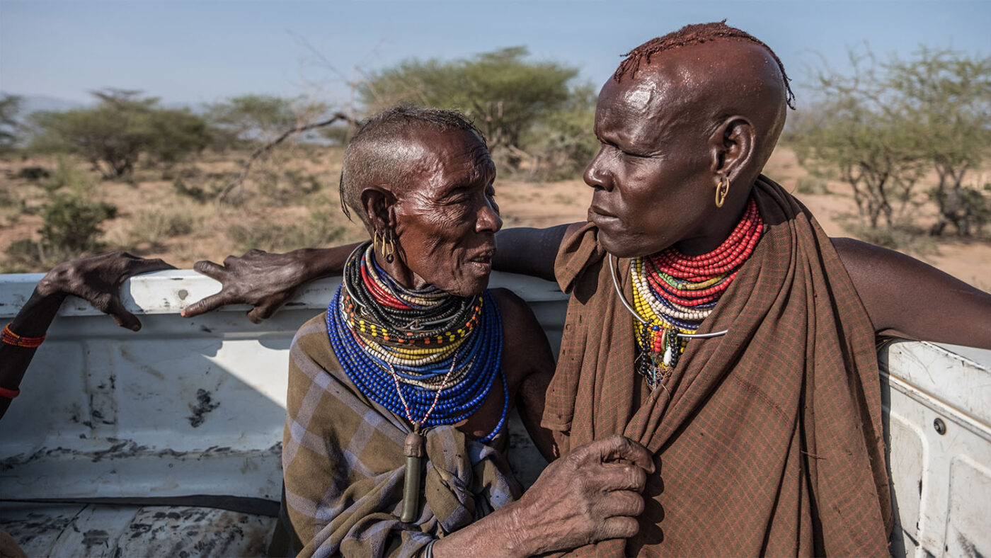 Amoni and Akai sitting the back of the Sightsavers vehicle on their way to surgery.