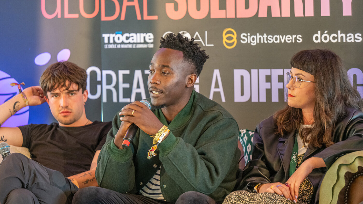 Three speakers sit onstage at a panel event supported by Sightsavers Ireland.