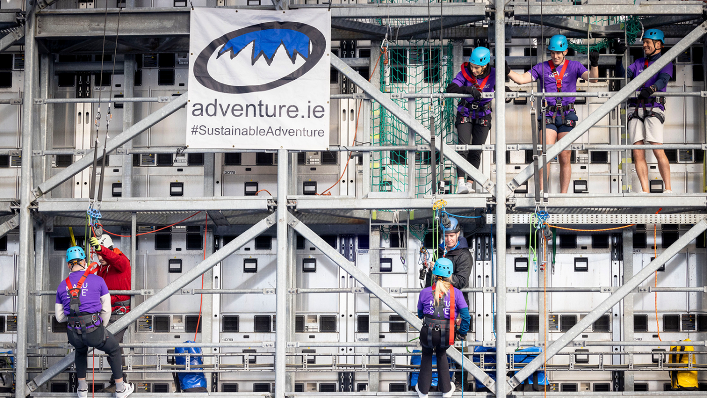 Participants abseiling down a scaffolding platform.