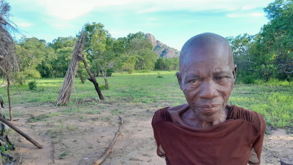 Caliha stands outside, with a tree behind her.
