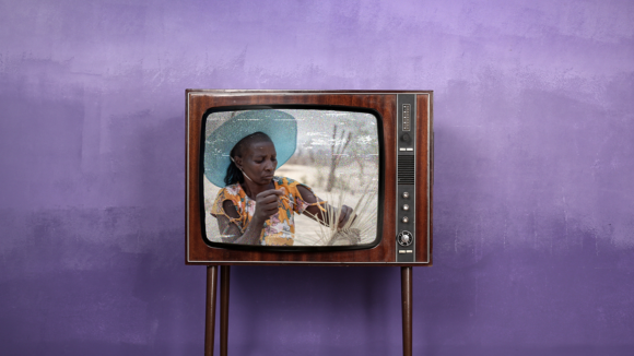 An old-fashioned television screen features an image of a woman weaving a basket.