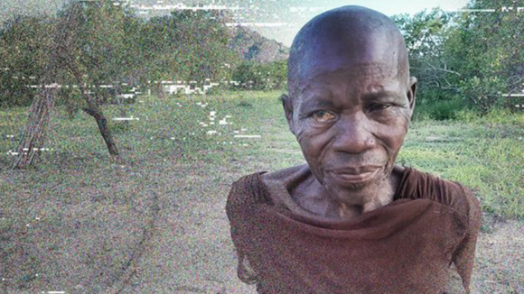 A portrait of Caliha who is looking away from the camera. She is standing outside, with a tree behind her.
