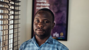 Rasak Adekoya stands in an office.